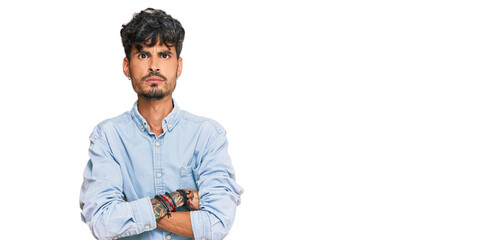 Young hispanic man wearing casual clothes skeptic and nervous, disapproving expression on face with...