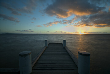 Fototapeta na wymiar Sunrise over the Lake Cootharaba from the Boreen Point Jetty