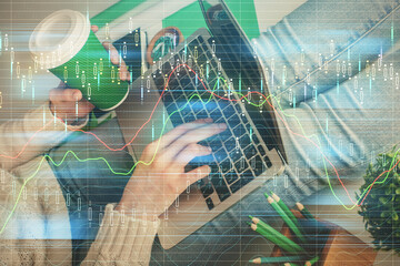 Double exposure of woman hands typing on computer and forex chart hologram drawing. Stock market invest concept.