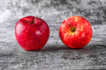Green and red apples on blackboard or chalkboard background. Bright fruit composition. Close-up on a gray background.