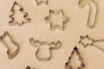 Gingerbread aromatic and spiced dough for Christmas cookies with different shape metal cookie cutters.Preparing Christmas cookies using cookie cutters. Close up view. Baking concept. Selective focus.