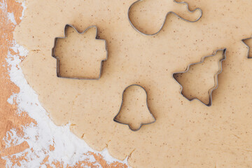 Gingerbread aromatic and spiced dough for Christmas cookies with different shape metal cookie cutters.Preparing Christmas cookies using cookie cutters. Close up view. Baking concept. Top view.
