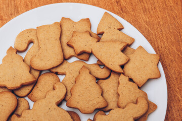 Tasty Christmas gingerbread cookies on the white plate.