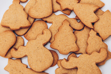 Tasty Christmas gingerbread cookies on the white plate.