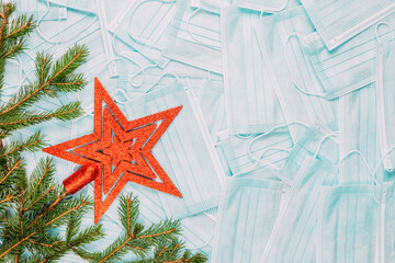 Fototapeta na wymiar Christmas star and Christmas tree twig on ANTI-COVID Masks background, medical face masks, flat lay, background