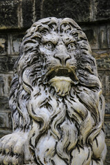 Sinaia, Romania, May 17, 2019: Marble sculpture. White stone lion. Architecture of the Middle Ages. European monuments. An ancient attraction.