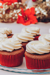 Delicious chocolate cupcakes with swirled frosting cream on top. Cupcakes on a glass tray with...