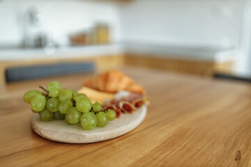 On the kitchen table, snack.