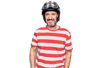 Middle age handsome motorcyclist man wearing moto helmet over isolated white background with a happy and cool smile on face. Lucky person.
