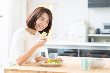 Obraz na płótnie Canvas サラダを食べる女性