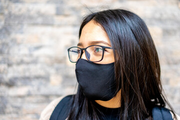 Portrait of beautiful smiling girl with glasses and mask