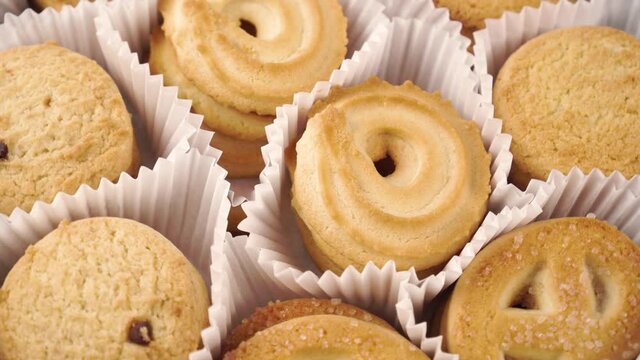 Close up shortbread cookies in a paper wrapper. Rotation
