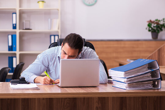 Young male employee working in the office