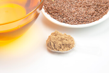 ground flaxseed and oil on a white background. vitamins and healthy food