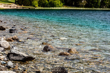 Rocks in the water of a lake. Stony shore in a lake.