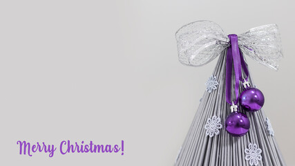 christmas gray tree with balls and ribbon