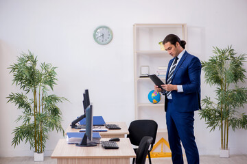 Young male employee working in the office