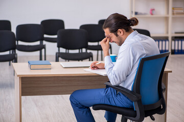 Young male boss giving seminar in the office during pandemic