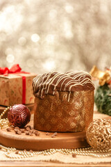 Chocolate panettone  on wooden table with christmas ornaments