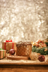 Chocolate panettone  on wooden table with christmas ornaments