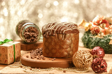 Chocolate panettone  on wooden table with christmas ornaments