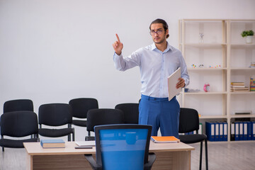 Young male boss giving seminar in the office during pandemic