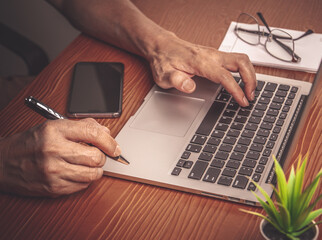 Working from home by laptop computer and smartphone