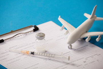 Vaccine with syringe, calendar 2021, and white plane, blue background