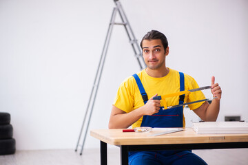 Young male carpenter working indoors