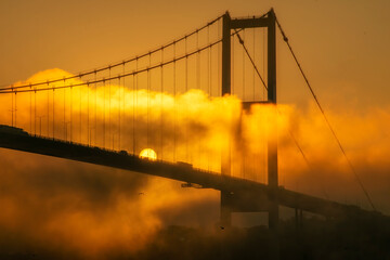 Fototapeta premium Foggy and Misty scene of Bosphorus Bridge. Bridge over the Bosphorus in Istanbul. View from the Asian part of Istanbul. The 15 July Martyrs Bridge in a fog