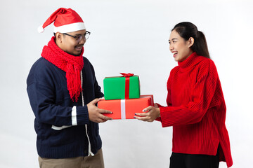Happy young couple on white background. Man is holding a gift box both are smiling