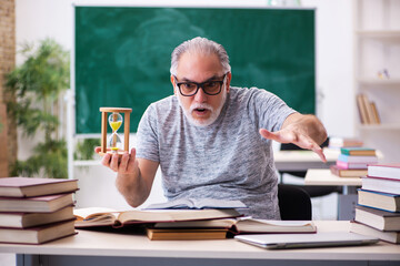 Old male student in time management concept