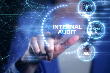 Business, Technology, Internet and network concept. Young businessman working on a virtual screen of the future and sees the inscription: Internal audit
