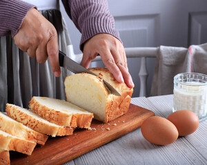 Female Chef Hold Knife to Cut or Slicing White Japanese Brioche Hokkaido Bread with Cheese Topping