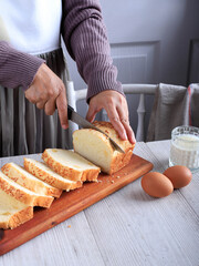 Female Chef Hold Knife to Cut or Slicing White Japanese Brioche Hokkaido Bread with Cheese Topping