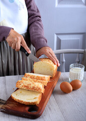 Female Chef Hold Knife to Cut or Slicing White Japanese Brioche Hokkaido Bread with Cheese Topping