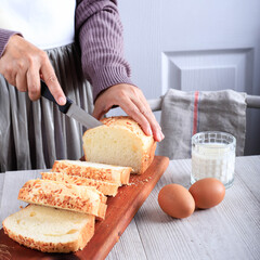 Female Chef Hold Knife to Cut or Slicing White Japanese Brioche Hokkaido Bread with Cheese Topping