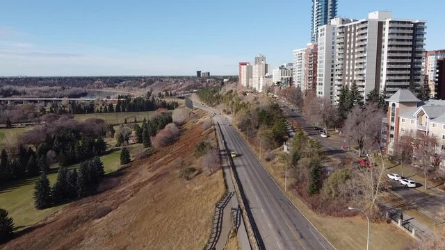 1-2 aerial rise fly over vip park adjacent to road by vip rivers ege condominiums apartments high rise tower on a blue sky sunny fall day with hardly any traffic at rush hour during COVID-19 pandemic