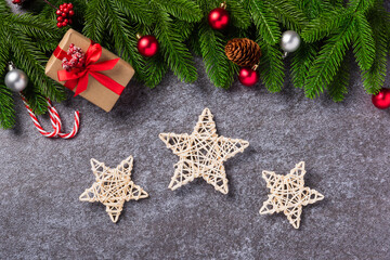 Christmas background. Top view border green pine cones fir tree branches with Xmas decoration, gift box and the star on concrete table background with copy space for text, Happy new year day concept