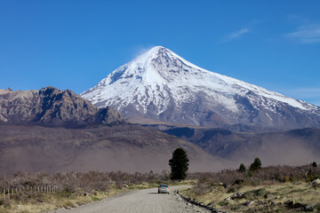 Fototapeta premium View of the Lanin Volcano from the road to Tromen Lake in Neuquen, Argentina. This volcano is covered by eternal snow.