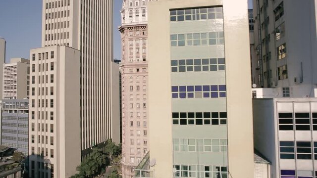 Aerial view of the Martinelli Buildings and other skyscrapers in Anhangabau, Sao Paulo, Brazil - tracking, drone shot