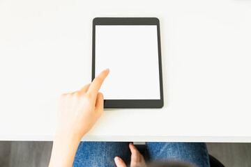 Woman hand using digital tablet and the screen is blank.