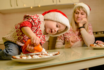 Santa kid making cookie for family in cozy kitchen. Santa helper