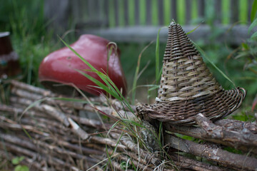 Cast iron and wicker Pots on a vine fence