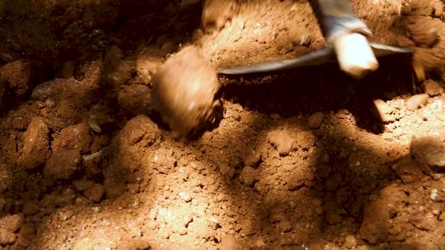 man preparing the land with a hoe