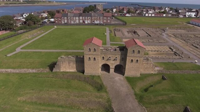 Reconstructed Gateway Of Arbeia, South Shields Roman Fort At Lawe Top Near Town Of South Shields, England, UK.- aerial descend