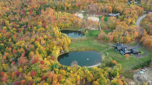 Aerial View of Colorful Forest, Ranch Ponds and Mansion in American Countryside. Smugglers Notch, Vermont USA
