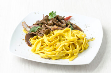 Peruvian food: Fettuccine with huancaina sauce and lomo saltado.