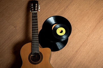 The guitar and record on wooden floor
