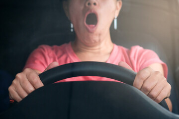 Sleepy woman While she was driving on the road. Concept of health and driving safety